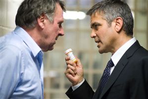George Clooney recommends anti-fruitbat medication to Tom Wilkinson.